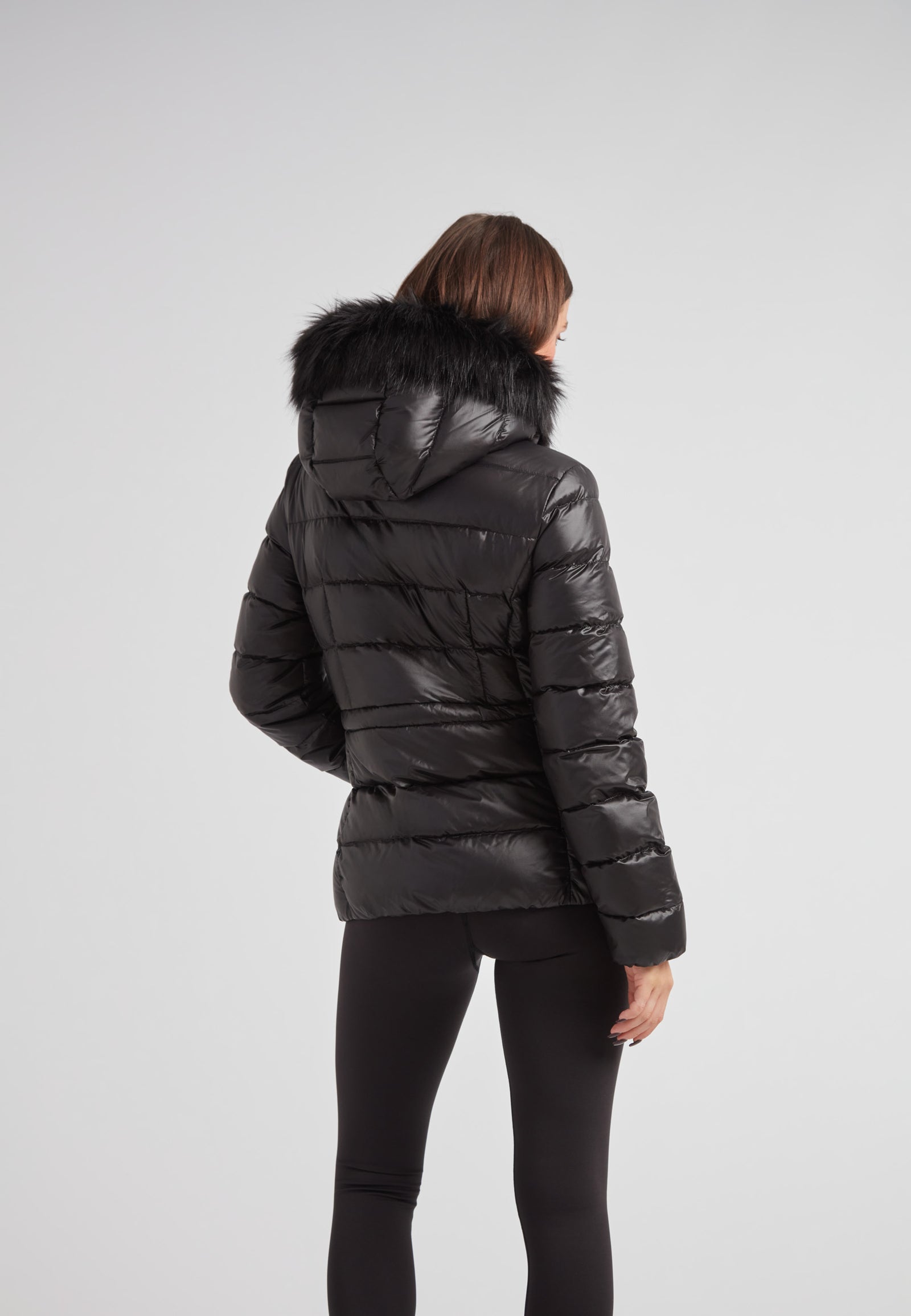 Back view of a Black racer puffer jacket with fur hood, showcasing its sleek design and luxurious materials.