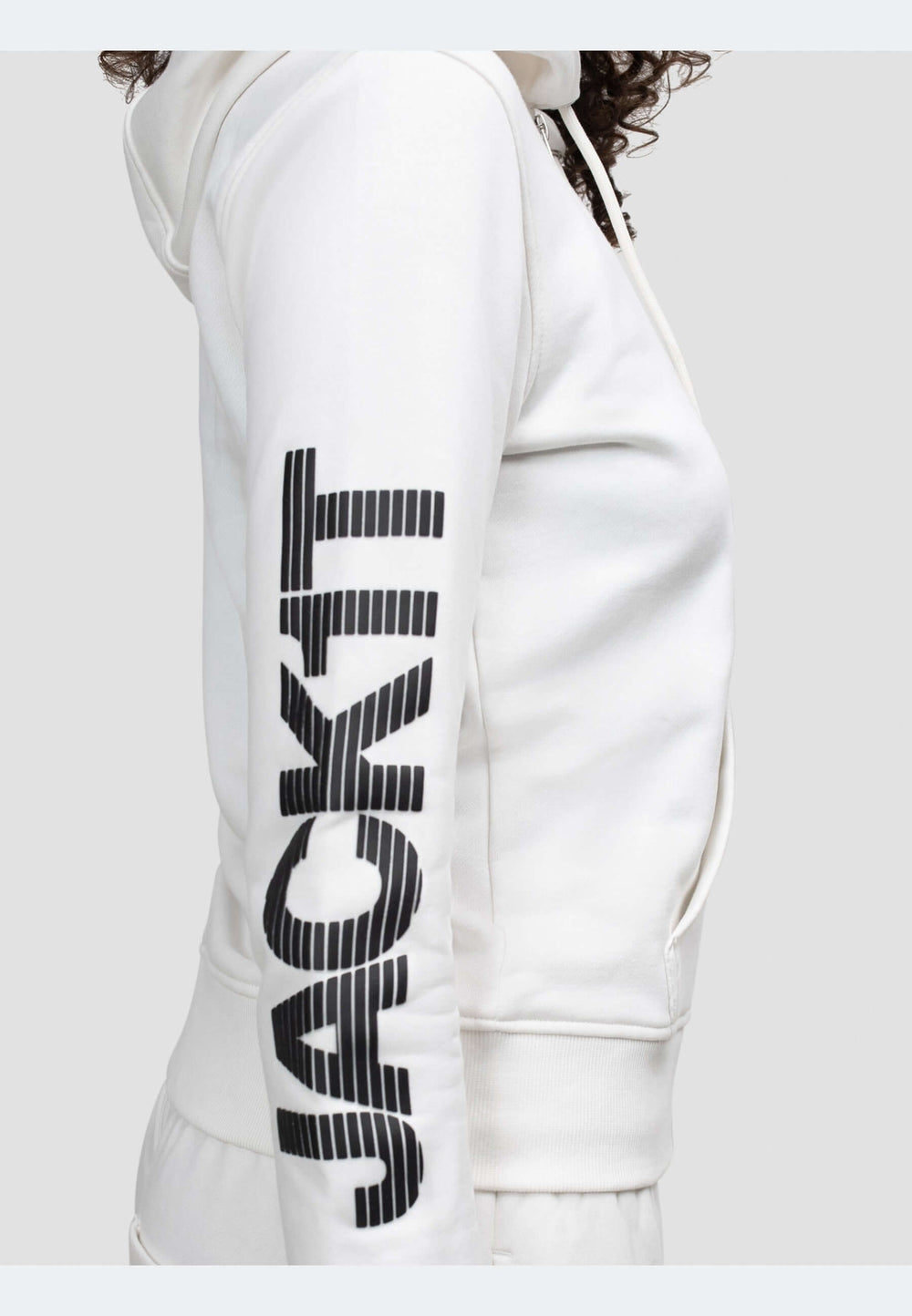 Side view of an off white hoodie with 'JACKIT' printed on the sleeve, showcasing a modern and stylish design.