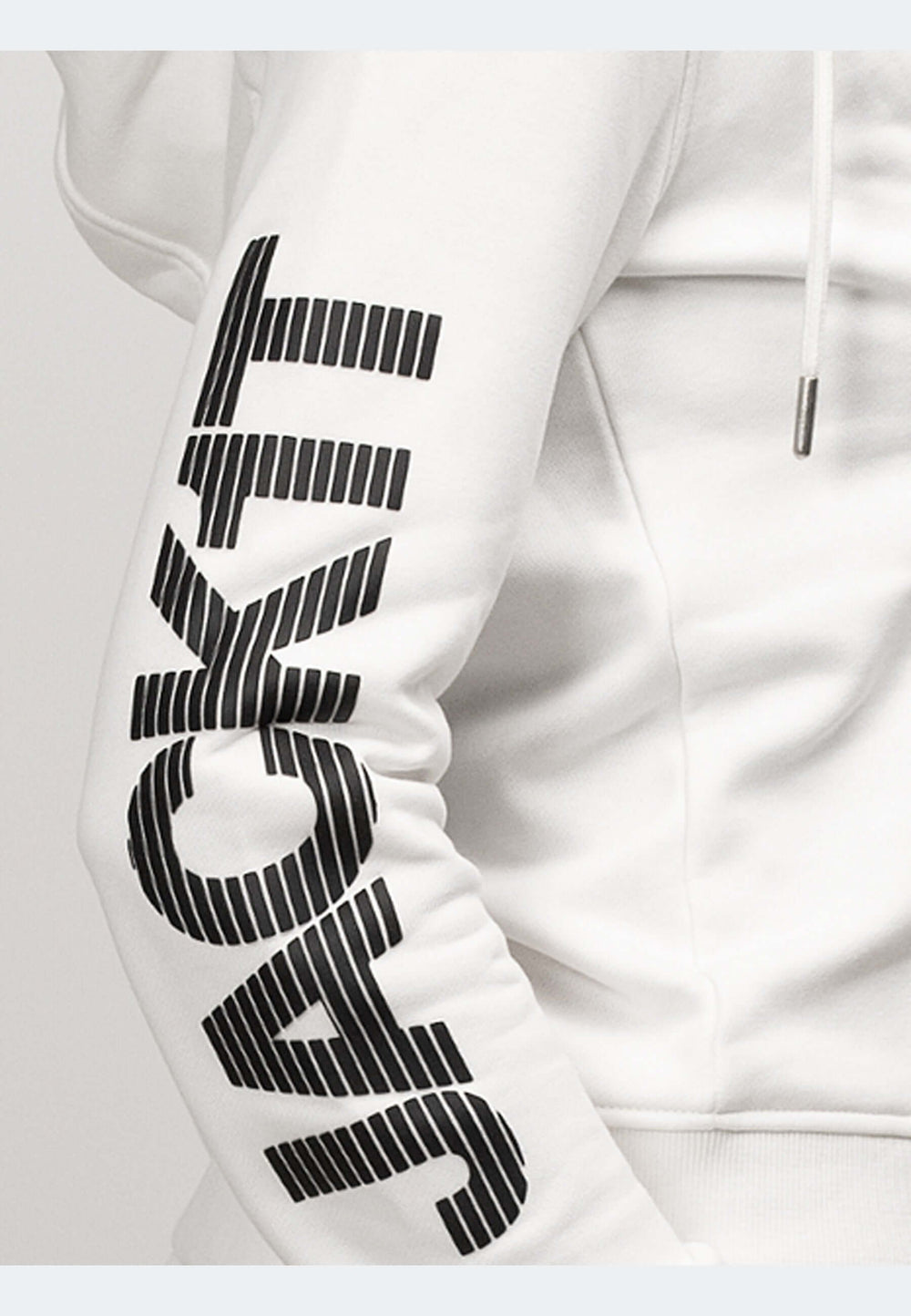 Close-up of off white hoodie showcasing zip-through design and bold logo on the sleeve.