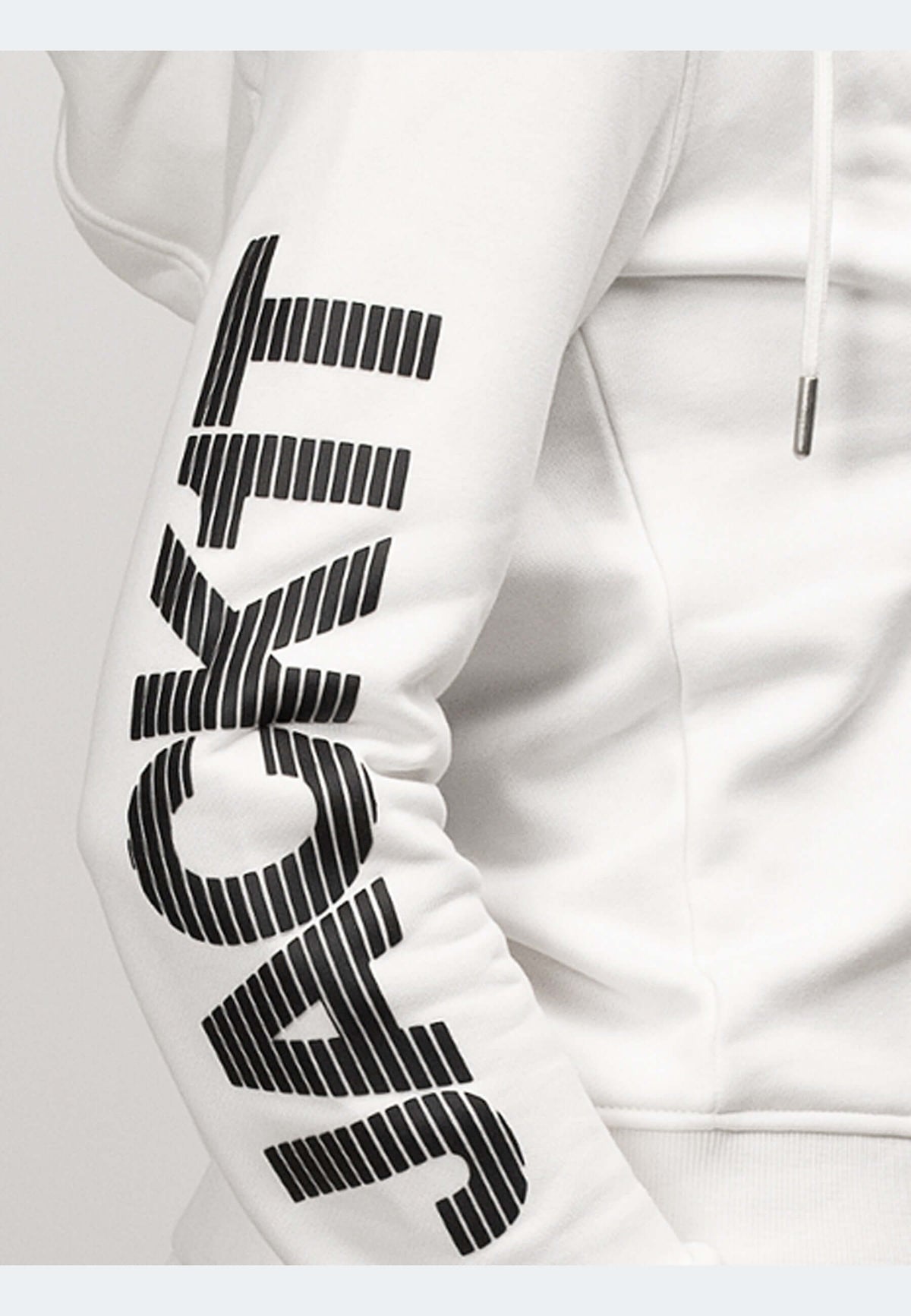 Close-up of off white hoodie showcasing zip-through design and bold logo on the sleeve.
