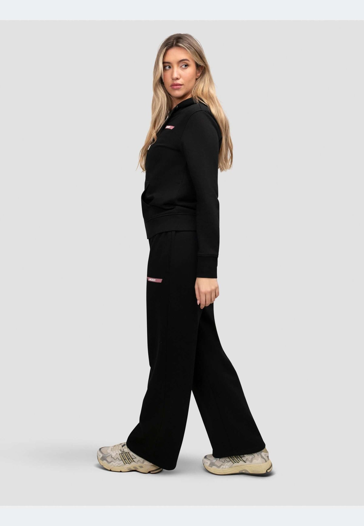 Black joggers paired with a matching top, showcasing a relaxed wide-leg silhouette and casual style.