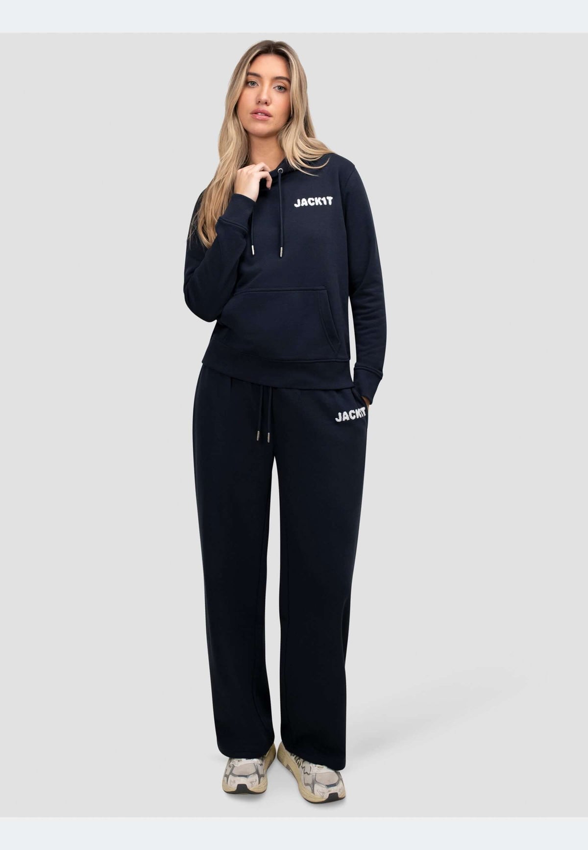 Woman wearing navy joggers with a matching hoodie, showcasing laid-back style and comfort.