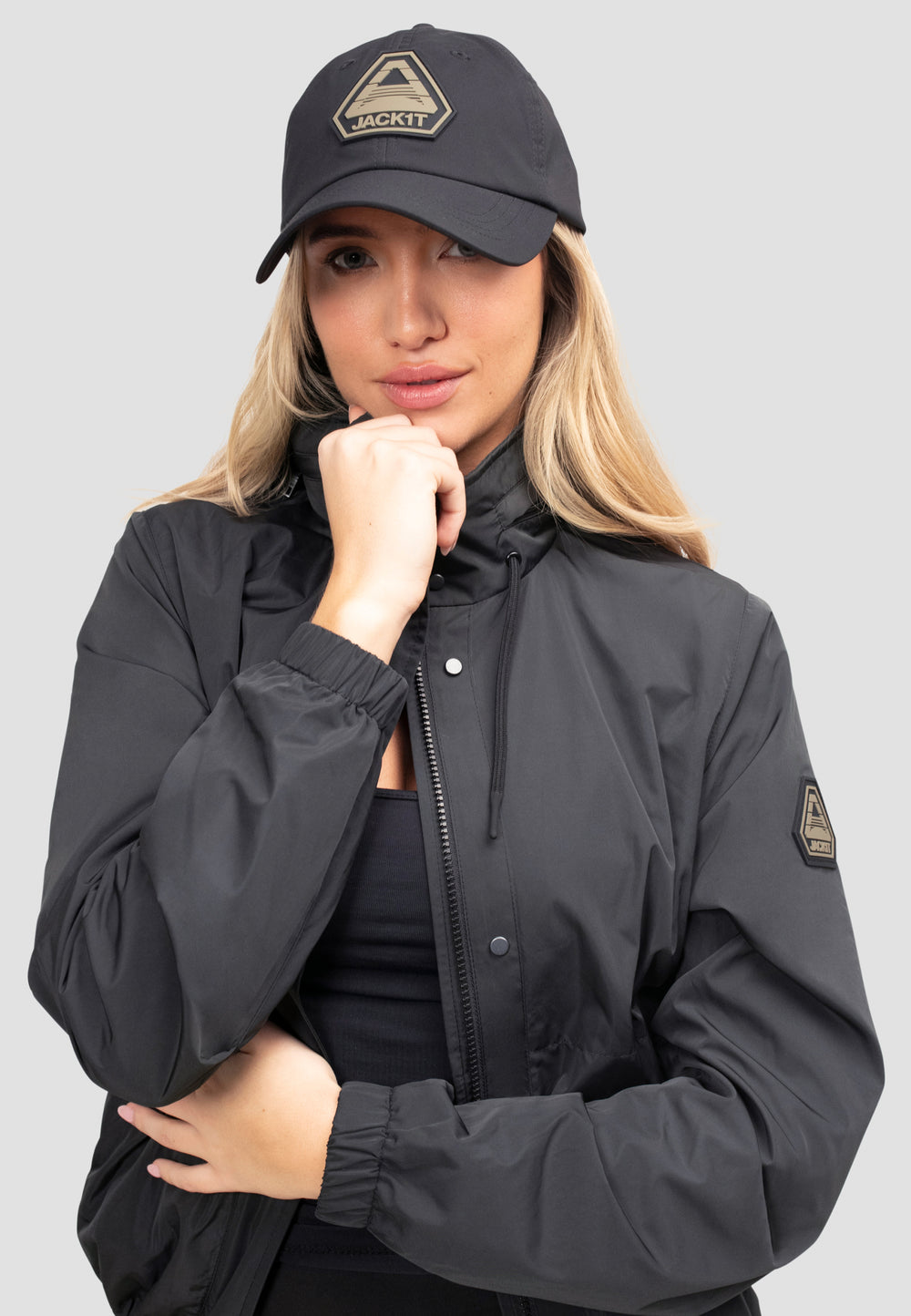 Women's Black Windbreaker on model with cap, perfect for spring and summer weather.