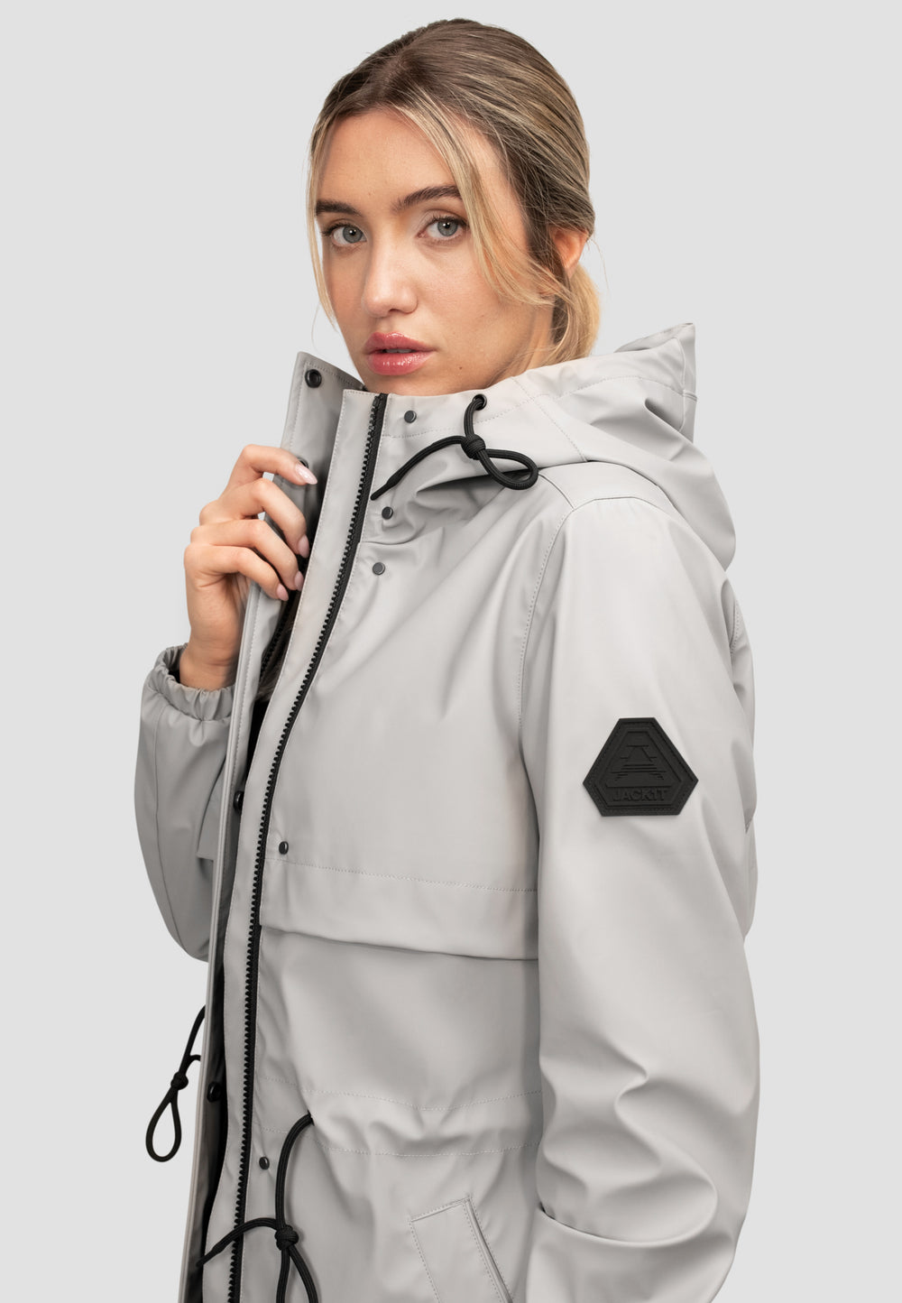 Model wearing women's grey raincoat, lightweight and stylish, perfect for unpredictable spring weather.