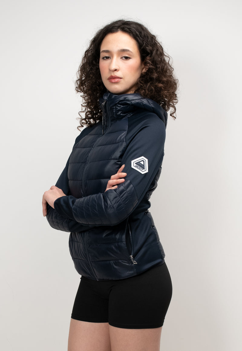 Womens Hybrid Hooded Jacket in Navy showcased on a model with curly hair, featuring a lightweight water-resistant design.