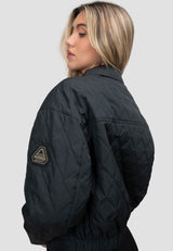 Womens Quilted Shirt Jacket in Black worn by a model showing the back view and quilted design.