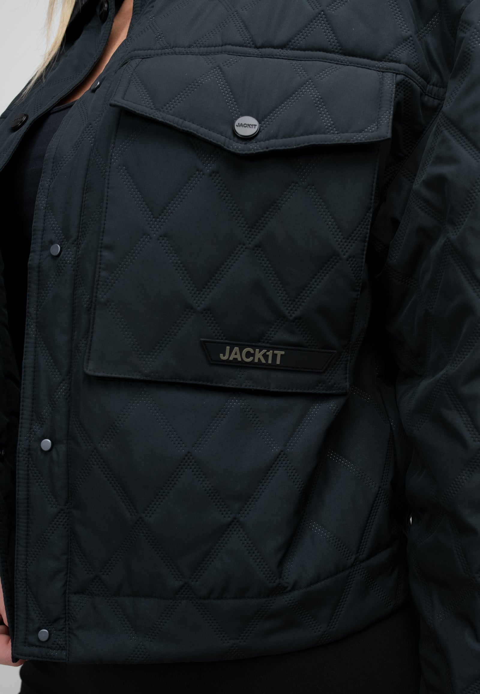 women's black quilted shirt jacket close-up showing pocket detail and quilted texture