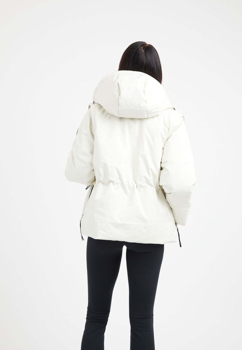 Back view of a woman wearing a Supernova Hood cream womens short puffer coat with an adjustable drawcord.