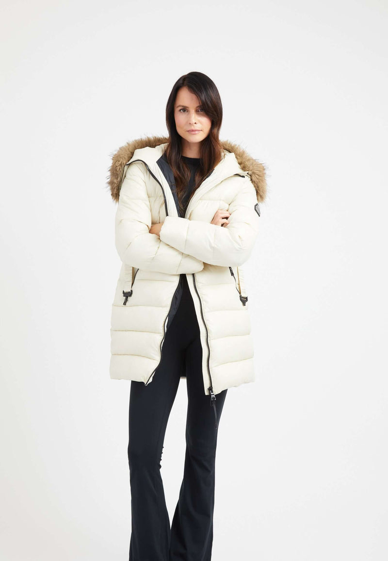 Model wearing a stylish Madero coat cream, featuring a hood and faux-fur trim, perfect for winter. Short cream puffer coat.