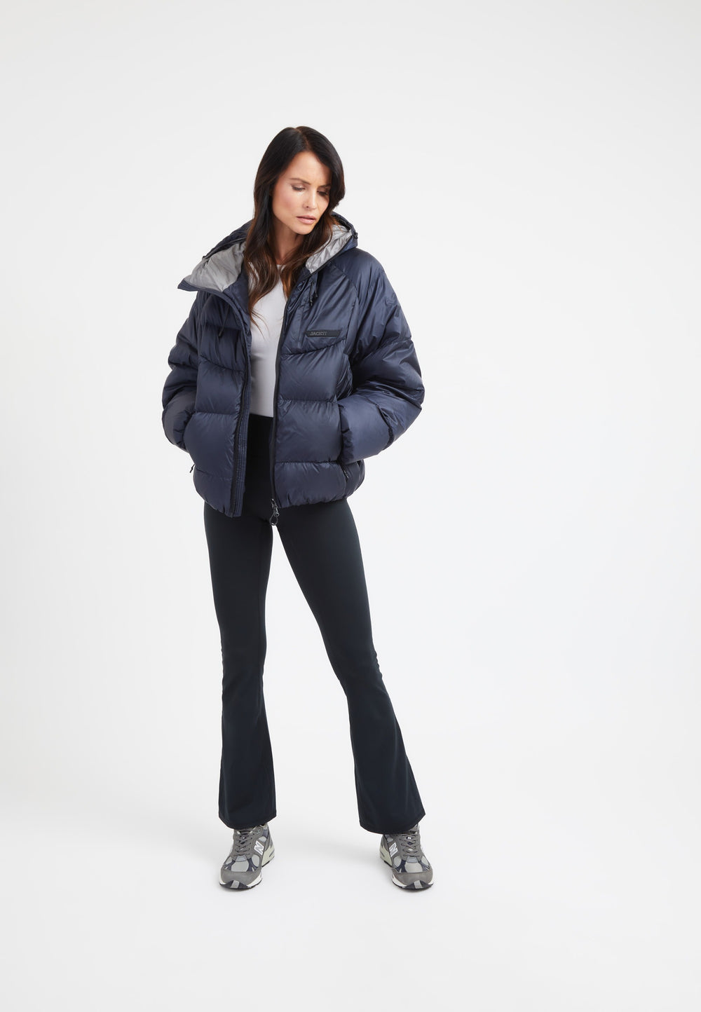 Model wearing an oversized puffer navy jacket with a modern silhouette and cozy fleece pockets.