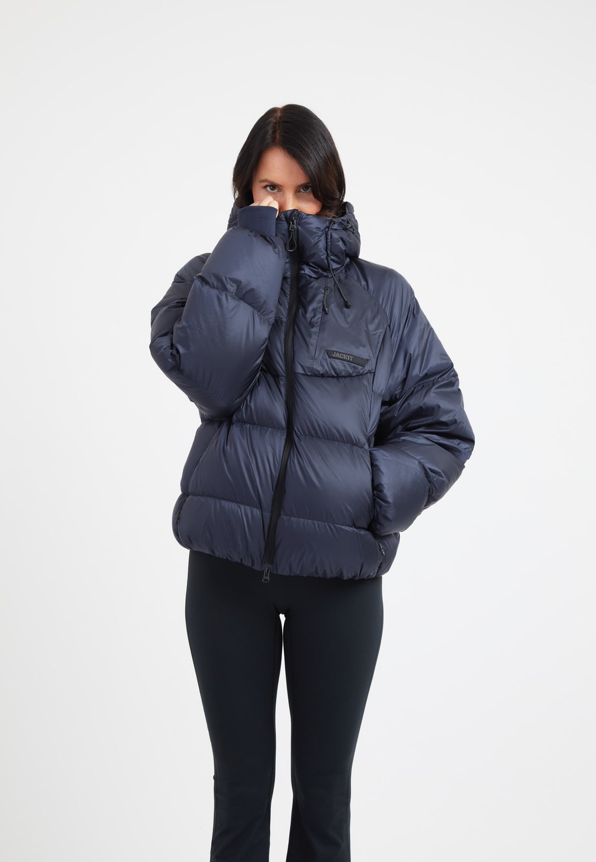 Model wearing an oversized puffer navy jacket, showcasing its cozy design and stylish fit.