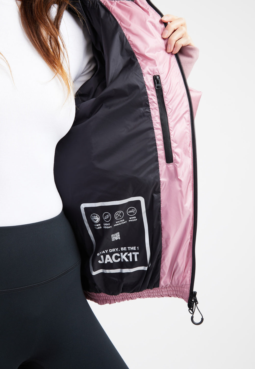 Inside view of an oversized puffer jacket in pink, showing care instructions and a stylish interior design.