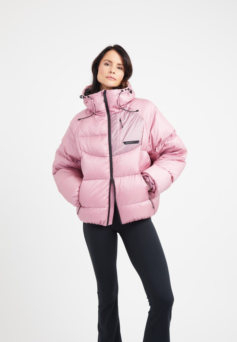 Model wearing an oversized puffer pink bubble jacket with adjustable hood and stylish design.
