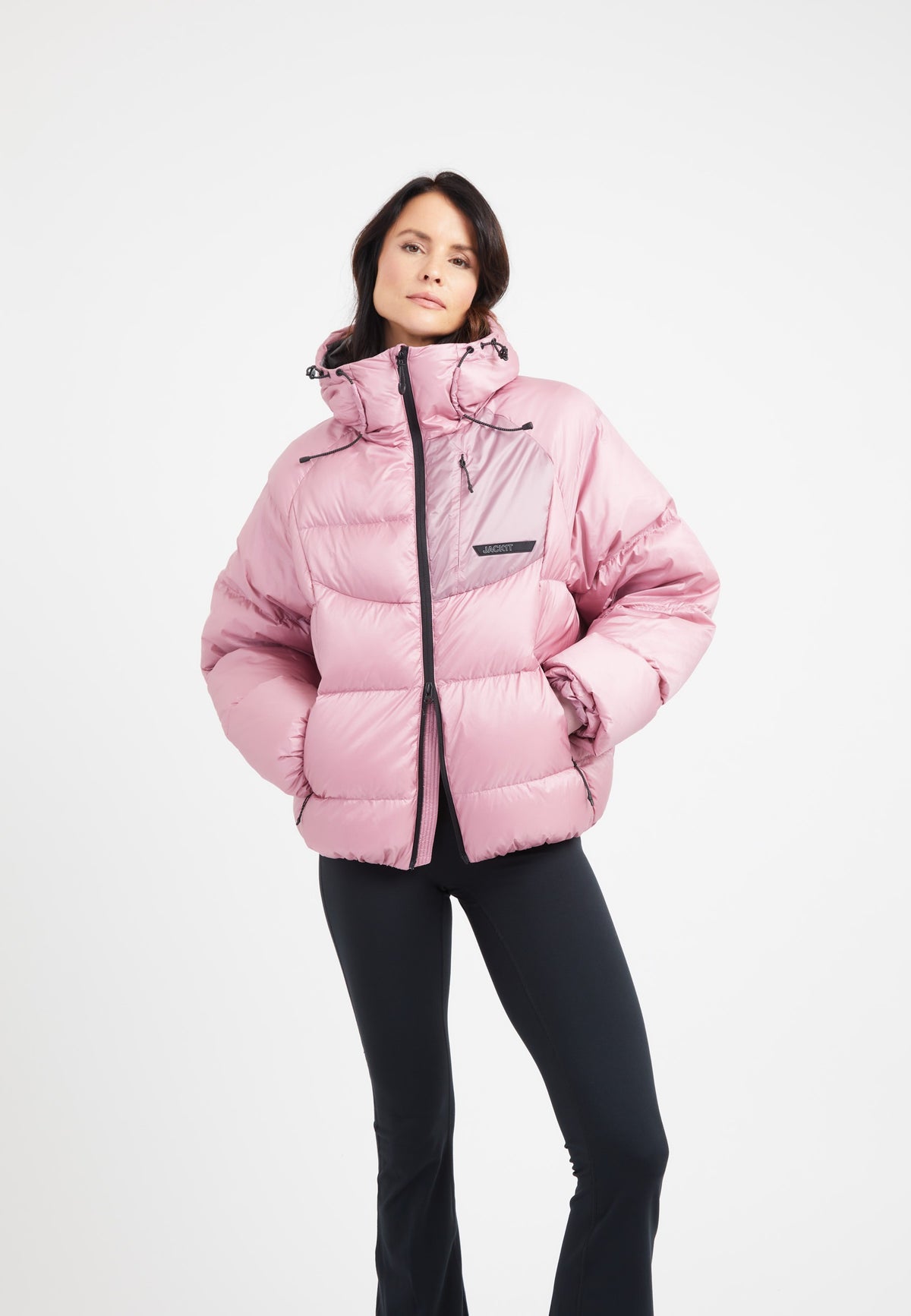 Model wearing an oversized puffer pink bubble jacket with adjustable hood and stylish design.