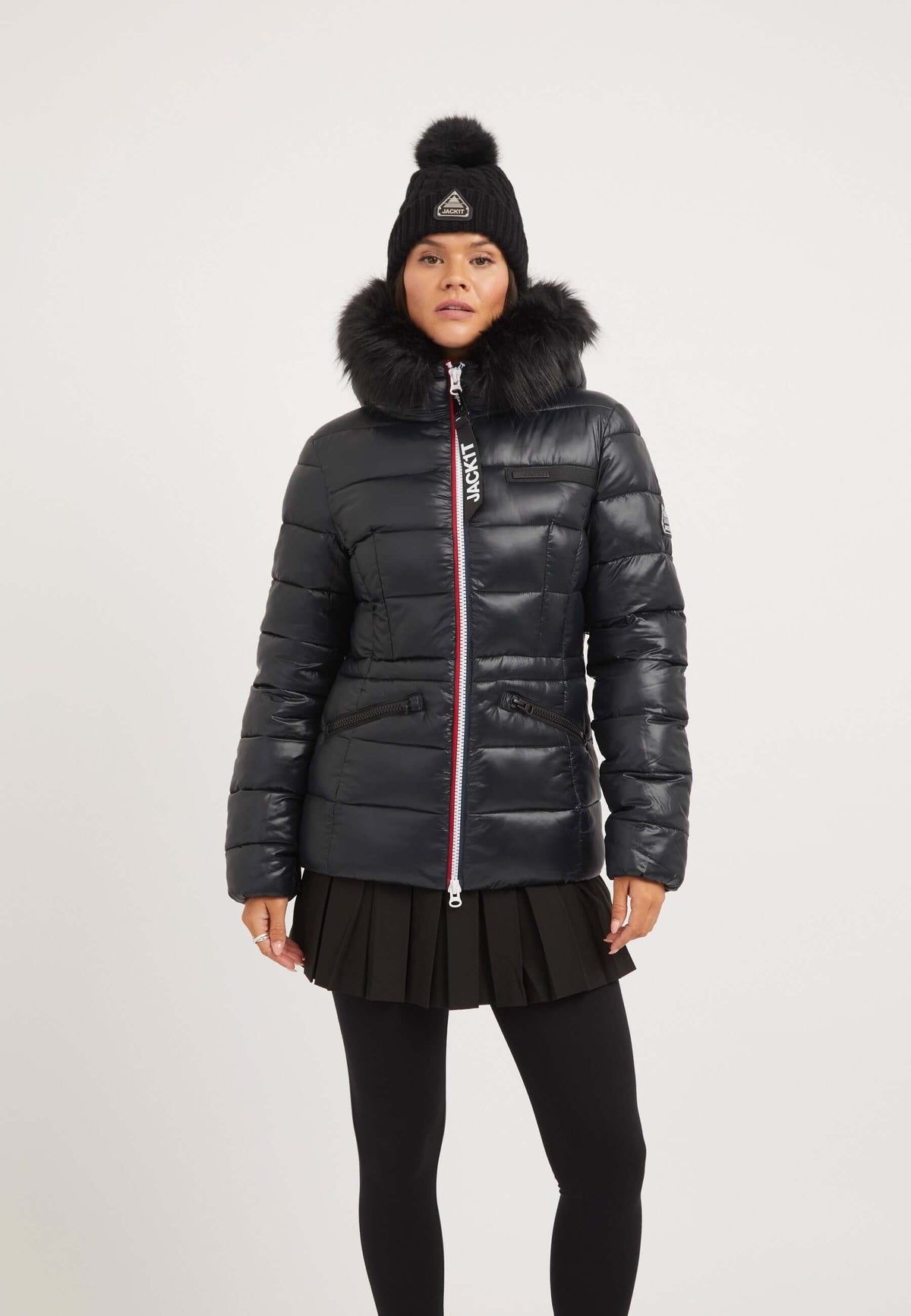 Black womens puffer jacket with removable faux-fur trim and tapered racer fit, worn by a model against a neutral background.