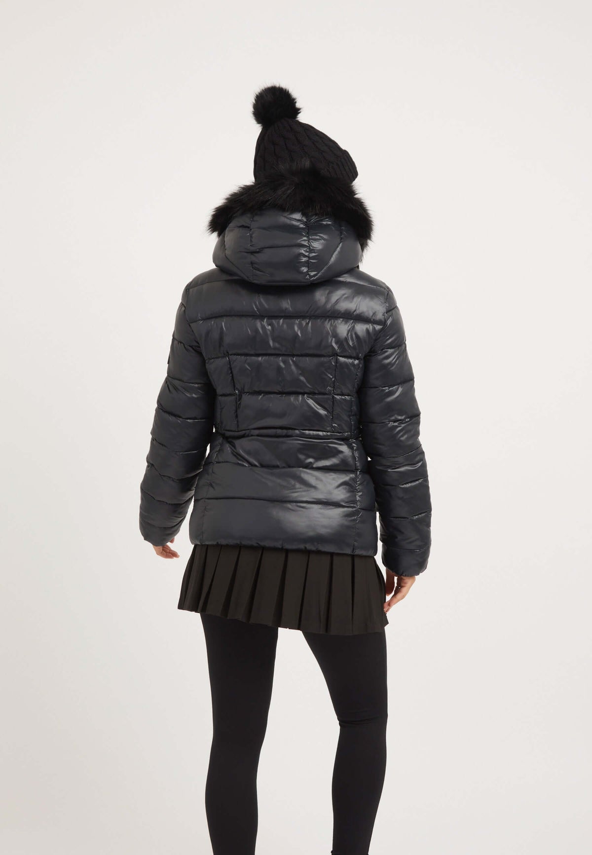 Back view of a woman wearing the R4D Tricolore Racer Jacket Black, a stylish black womens puffer jacket with faux-fur trim.